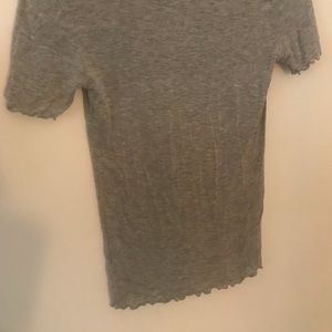 Tight grey ruffled shirt.